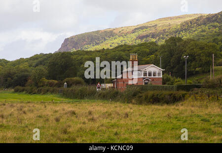 The refurbished automatic rail crossing and station house at Magilligan on the North coast of Ireland in County Londonderry on a dull day Stock Photo