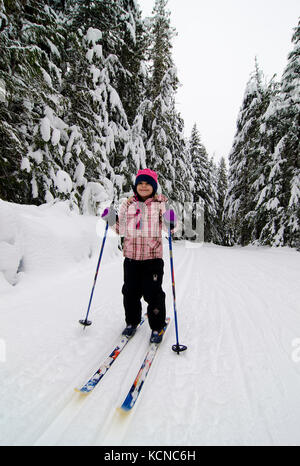 Young girl (7) enjoys a day cross-country skiing at Larch Hills Nordic Centre near Salmon Arm in the Shuswap region of British Columbia, Canada Stock Photo