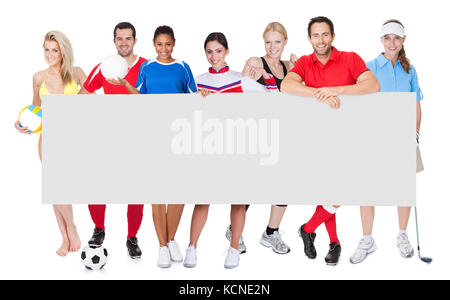 Group of sports people presenting empty banner. Isolated on white Stock Photo