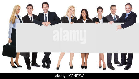 Group of business people presenting empty banner. Isolated on white Stock Photo