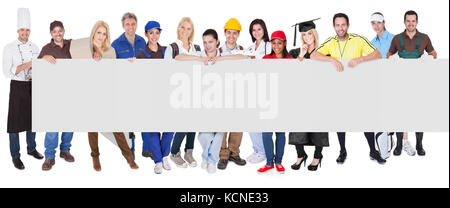 Group of diverse professionals presenting empty banner. Isolated on white Stock Photo