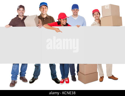 Group of delivery people presenting banner. Isolated on white Stock Photo