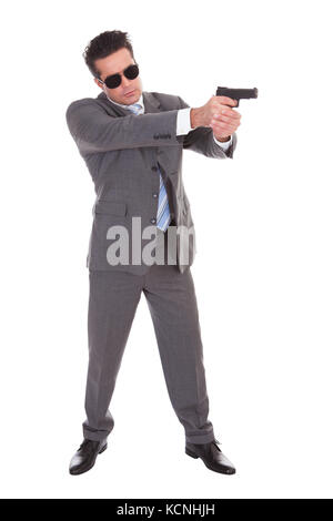 Portrait Of Young Handsome Man With Black Sunglasses And Gun Stock Photo