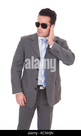 Portrait Of Young Man With Finger On Ear Stock Photo