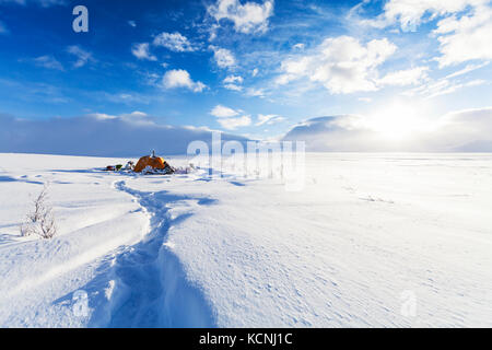 Snowmobilers winter camp while attempting to cross the North Canol heritage trail running between Yukon Territory and the North West Territories, Canada Stock Photo