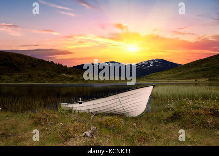Boat in front of a river in jotunheimen norway Stock Photo