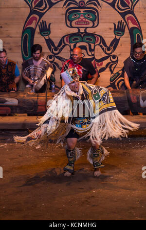 A first nation dancer performs for an audience during aboriginal days at the Komok's bighouse, Comox, The Comox Valley, Vancouver Island, British Columbia, Canada Stock Photo