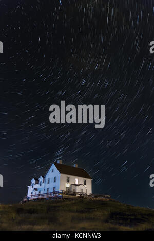 Night sky,  star Trails over an old fish Merchants residence, Cange Islands, Newfoundland & Labrador Stock Photo
