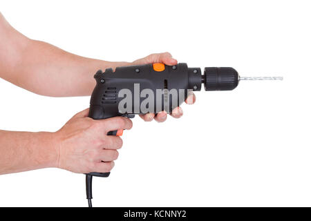 Close-up Of Male Hand Holding Drill Tool Over White Background Stock Photo