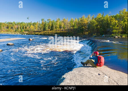 hiker, autumn, Rainbow Falls along the Whiteshell River, Whiteshell Provincial Park, Manitoba, Canada Stock Photo