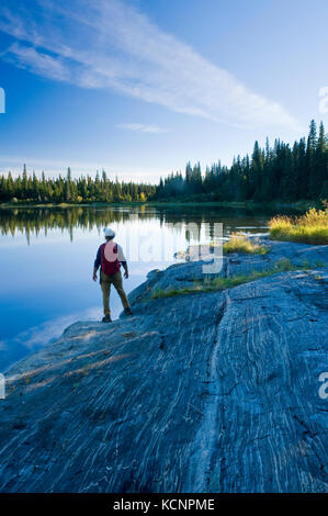 hiker along the Grass River, Pisew Falls Provincial Park, Manitoba, Canada Stock Photo