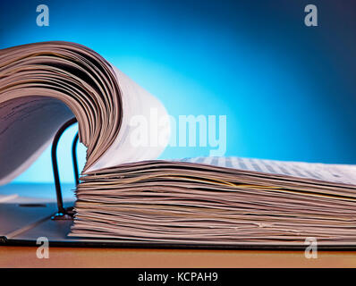 Detail of an open file folder on a blue background Stock Photo