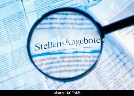 Magnifier focuses on job opportunities in a daily newspaper Stock Photo