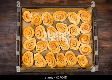 Homemade cinnamon rolls on wooden table Stock Photo
