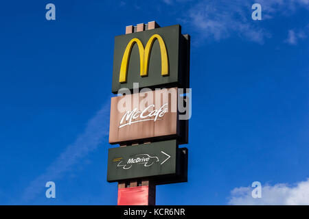 McDonald's sign drive McDrive, McCafe logo sign, Czech Republic blue sky background Stock Photo