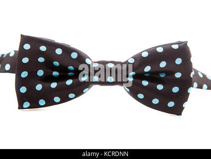 Elegant black bow tie in blue polka dots on an isolated white background. Stock Photo