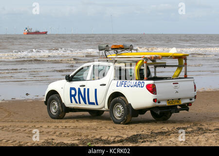 UK Weather:  RNLI volunteer Lifeguards practice rescue land-based ﬁrst aid training & recovery on the beach at high tide.  Simulated rescues are used to practice responding under different conditions, Crosby Coastal Park, Merseyside, UK Stock Photo