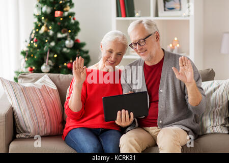 happy senior couple with tablet pc at christmas Stock Photo