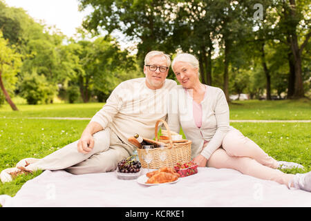 happy senior couple having picnic at summer park Stock Photo