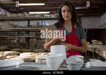 Portrait of confident female potter standing with arms crossed Stock ...