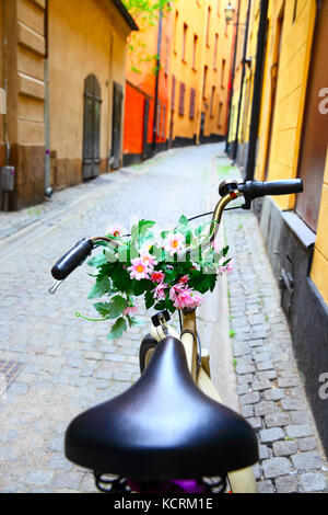 Bicycle with bunch of flowers on handle bar in Stockholm, Sweden Stock Photo