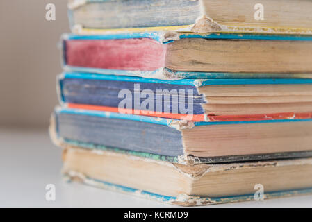 Vintage hardcover books in pile on table Stock Photo