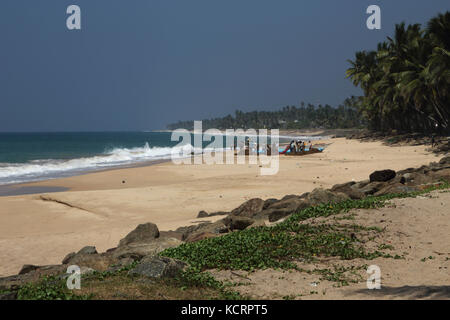 Hikkaduwa Southern Province Sri Lanka Fishermen Tending Nets by Boat on the Beach Stock Photo