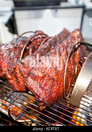 BBQ pork ribs cooking on a smoker Stock Photo