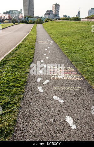Colorful painted museum sign on asphalt pavement of plaines d'Abraham Road to the Museum at the Citadelle of Quebec City, Canada Stock Photo