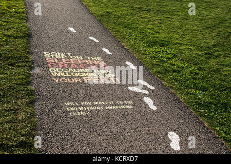 Colorful painted museum sign on asphalt pavement of plaines d'Abraham Road to the Museum at the Citadelle of Quebec City, Canada Stock Photo