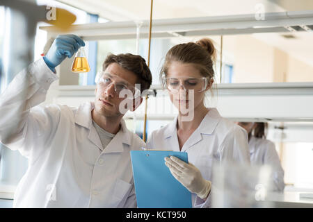Students doing experiment in laboratory at colllege Stock Photo