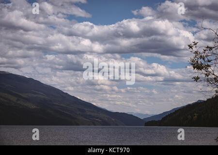 View of beautiful mountains, cloudscape and lake on a sunny day Stock Photo