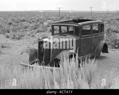 Old Route 66 relic in Painted Desert, Arizona. Utility poles in background line old highway right of way. Stock Photo