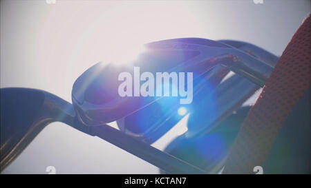 Set, Bunch of Golf club. Golf club against the background of blue sky. Bunch of golf clubs in the bag. Golf clubs over green field background. Bunch of clubs in the bag over blue sky background. Stock Photo