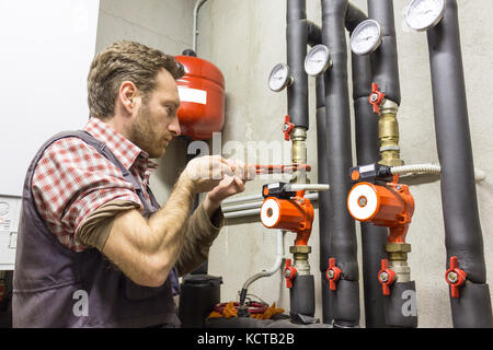 plumber at work installing a circulation pump Stock Photo