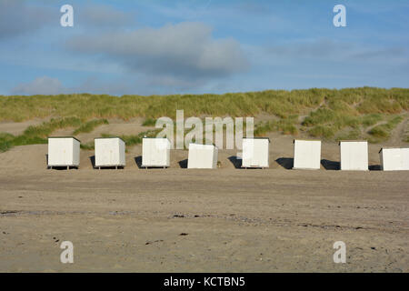 Beach cabins before beach oat in the dunes on the North Sea coast, in the Netherlands on Zeeland Stock Photo