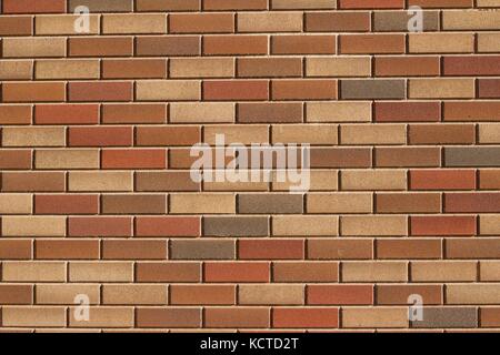 Attractive modern brick wall background with varying shades of light brown colored bricks in traditional design. Stock Photo