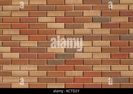 Attractive modern brick wall background with varying shades of light brown colored bricks in traditional design. Stock Photo