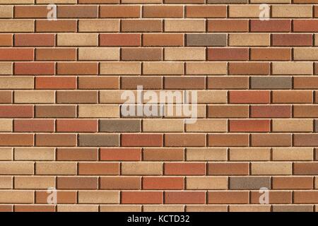 Attractive modern brick wall background with varying shades of light brown colored bricks in traditional design. Stock Photo