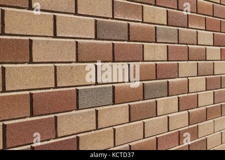 Attractive modern brick wall background with varying shades of light brown colored bricks in traditional design. Stock Photo