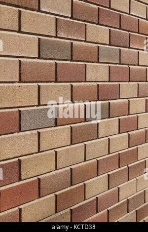 Attractive modern brick wall background with varying shades of light brown colored bricks in traditional design. Stock Photo