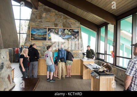 Park rangers giving information to the park visitors / tourists on the current conditions at the Logan Pass Visitor Center, Glacier NP Stock Photo