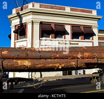 logging truck passes The Union Democrat Newspaper offices. Sonora, California Stock Photo