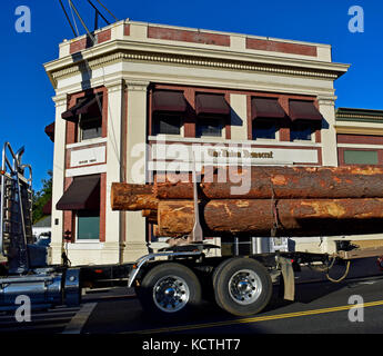 logging truck passes The Union Democrat Newspaper offices. Sonora, California Stock Photo