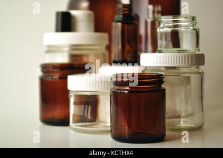 Clear and brown laboratory glass jars and bottles. Containers for essential  oils, cosmetics, medication, oils, liquids, creams and lotions Stock Photo  - Alamy