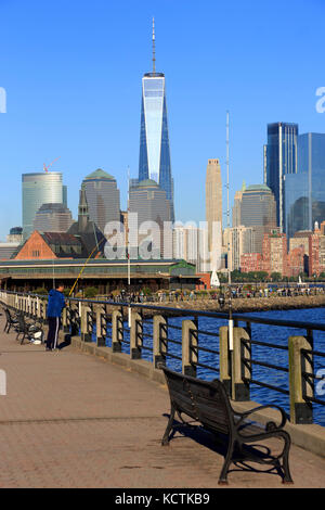 People fishing in Liberty State Park with skyline of Lower Manhattan in background.Jersey City,New Jersey.USA Stock Photo