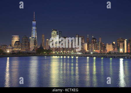 The night view of Lower Manhattan skyline with One World Trade Center tower in Financial Distric and Brooklyn.Manhattan,New York City,New York.USA Stock Photo