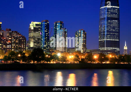 Night view of Jersey City skyline with Goldman Sachs &Co Tower and Manhattan skyline in the background.New Jersey.USA Stock Photo