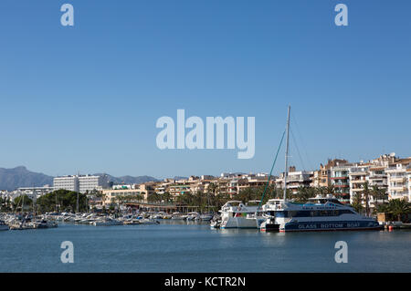Boats moored at harbour, buildings  in background, Puerto de Alcudia, Alcudia, Majorca, Balearic Islands, Spain. Stock Photo