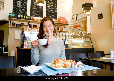 Woman in coffee shop, Fitzroy, Victoria, Australia Stock Photo